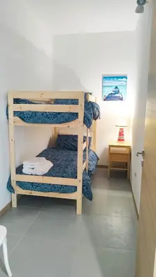 a room with three bunk beds in a room at Residence Spiaggia Centro - Aria Condizionata Wi-Fi&SelfCheck-In - Sole&Mare Home in Balestrate
