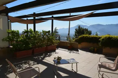 a patio with chairs and a view of the water at Casa Paola in Monreale