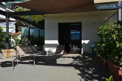 a patio with chairs and a table in front of a building at Casa Paola in Monreale
