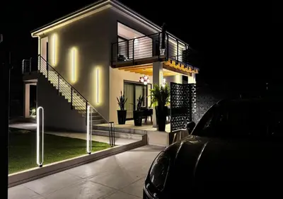a house at night with a car parked in front of it at Alba Gold LUXURY SUITE & VILLA in Cefalù