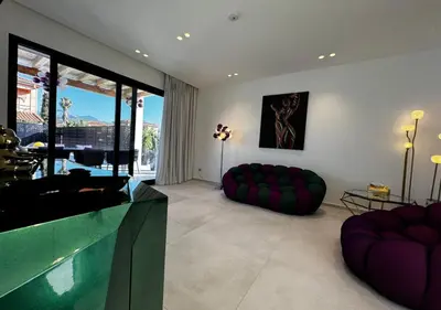 a living room with couches and a pool at Alba Gold LUXURY SUITE & VILLA in Cefalù