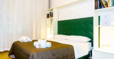 a bedroom with a bed with two towels on it at Suite in Center Apartments in Palermo
