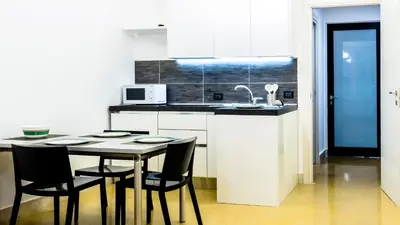 a kitchen with a table and chairs and a microwave at Suite in Center Apartments in Palermo