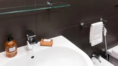 a bathroom with a white sink and a mirror at Suite in Center Apartments in Palermo