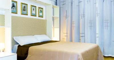 a bedroom with a bed with blue curtains at Suite in Center Apartments in Palermo