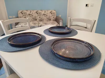 three plates sitting on top of a white table at Le Mura Home in Palermo