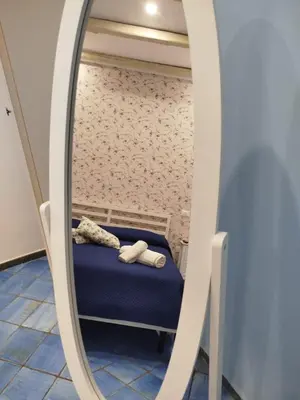 a room with a bed and a mirror at Le Mura Home in Palermo