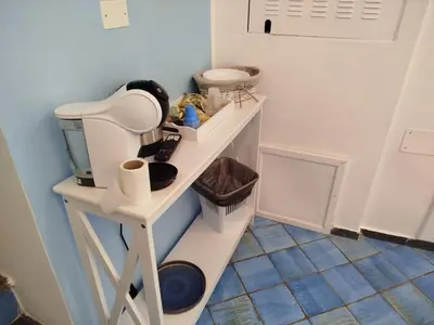 a bathroom with a shelf with a hair dryer at Le Mura Home in Palermo