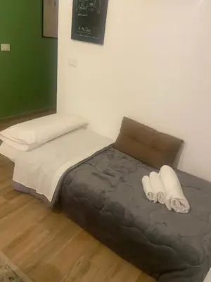 a bed with two white towels on it in a room at A me casa in Palermo