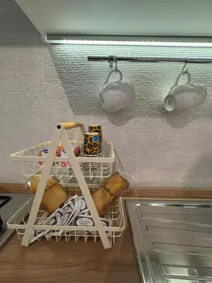 a shelf in a kitchen with food and lights at A me casa in Palermo