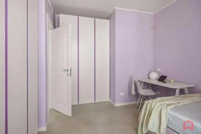 a bedroom with a bed and a desk and a door at Brand New Villa with Private Heated Pool in Terrasini