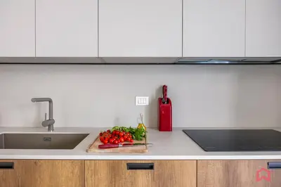 a kitchen counter with a sink and vegetables on a cutting board at Brand New Villa with Private Heated Pool in Terrasini