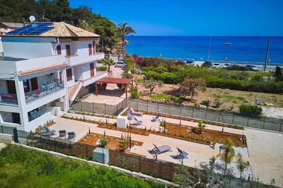 a white house with a view of the ocean at Le Residenze di Zio Toto' in Scopello