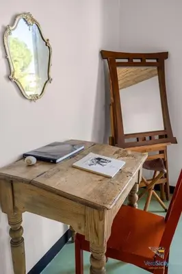 a wooden table with a mirror and a laptop on it at Verosicily Villa Damus in Terrasini