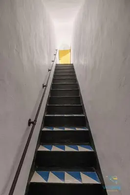 a stairway with a yellow door in a building at Verosicily Villa Damus in Terrasini