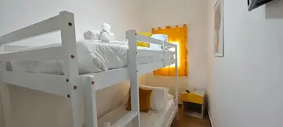 a white bunk bed in a small room at Cozy Apartment with Stunning Mountain Views in Lascari