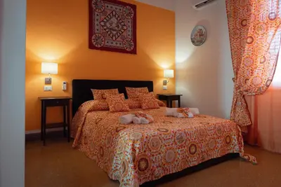 a bedroom with a bed with stuffed animals on it at Le Meraviglie della Sicilia in Palermo