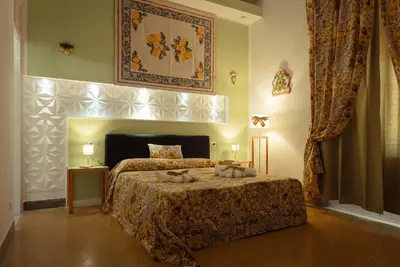 a bedroom with a bed in a room at Le Meraviglie della Sicilia in Palermo