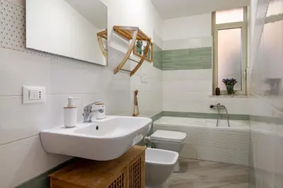 a bathroom with a sink and a toilet and a tub at GuestHost - The Flavour of Palermo - Kalsa Lovely Apartment in Palermo