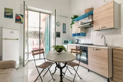 a kitchen with a table and chairs in a room at GuestHost - The Flavour of Palermo - Kalsa Lovely Apartment in Palermo