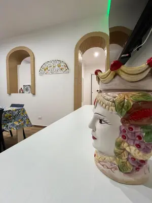 a statue of a head with fruit on a table at Casa Vacanze di Maria in Palermo
