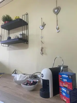 a kitchen counter with a toaster and bowls on a table at Sicily Holiday Home in Termini Imerese