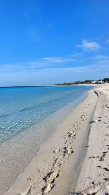 a beach with footprints in the sand and water at Casa Vacanza Ciglietti in San Vito lo Capo