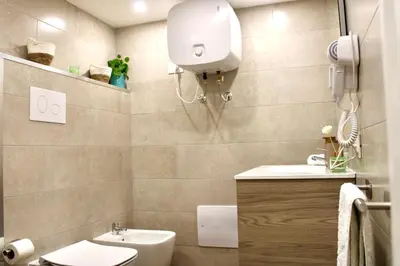 a small bathroom with a toilet and a sink at Pillis House, accogliente appartamento in centro città, vicino al Politeama Palermo in Palermo