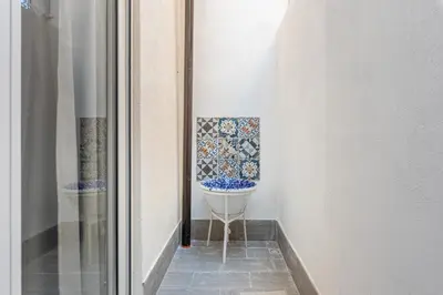 a bathroom with a toilet in the corner of a room at Casa Lolli by Wonderful Italy in Palermo