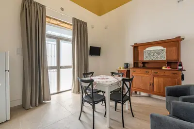 a dining room with a table and chairs at Casa Lolli by Wonderful Italy in Palermo