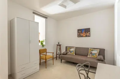a living room with a couch and a chair at Casa Lolli by Wonderful Italy in Palermo