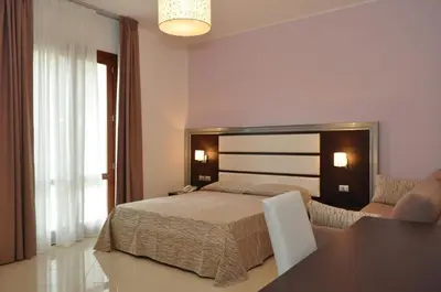 a bedroom with a bed and a table and a couch at Dolce Siesta in Castelluzzo