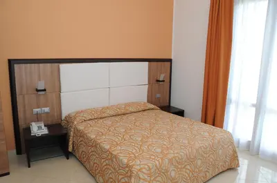 a bedroom with a bed and a phone on a table at Dolce Siesta in Castelluzzo