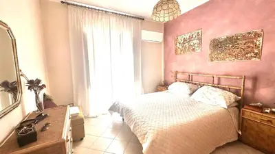 a bedroom with a bed and a mirror and a window at Fajra house in Palermo