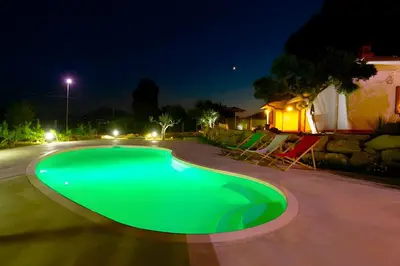 a swimming pool in a yard at night at Villa Due Pini con piscina privata in Alcamo