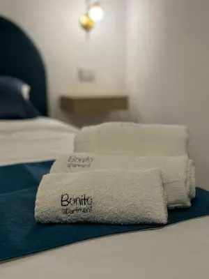 a pile of towels sitting on top of a bed at bonito apartment2 in Palermo