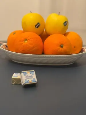 a plate of oranges and apples on a table at bonito apartment2 in Palermo