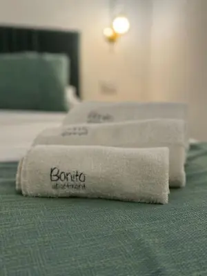 three towels sitting on top of a bed at bonito apartment in Palermo
