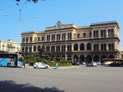 a large building with cars parked in front of it at bonito apartment in Palermo
