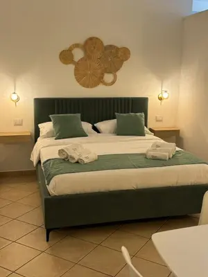 a bedroom with a large bed with two towels on it at bonito apartment in Palermo