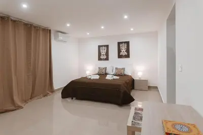 a bedroom with a bed and two lamps and a table at Dimora del Moro in Palermo