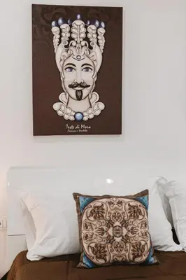 a picture of a head on a bed with a pillow at Dimora del Moro in Palermo