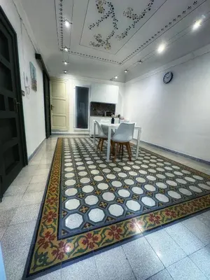 a dining room with a table and a rug at Allalbergheria Apartment in Palermo