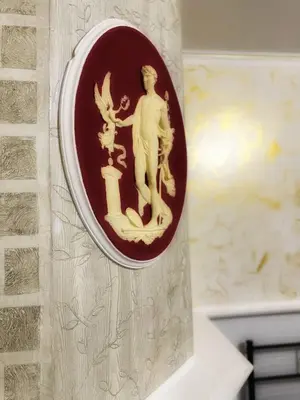 a plate on a wall with a man on it at Allalbergheria Apartment in Palermo