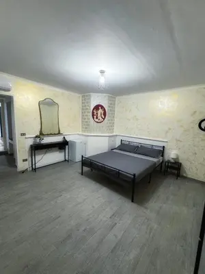 a large room with two beds and a mirror at Allalbergheria Apartment in Palermo