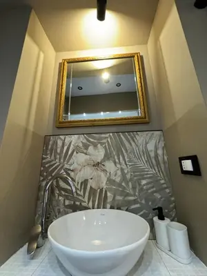 a bathroom with a white sink and a mirror at Allalbergheria Apartment in Palermo