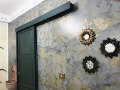 a wall with a green door and mirrors on it at Allalbergheria Apartment in Palermo