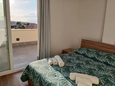 a bedroom with a bed with towels on it at HolidayHouse Belvedere in Terrasini
