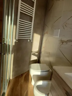 a bathroom with a white toilet and a sink at HolidayHouse Belvedere in Terrasini