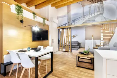 a dining room and living room with a white table and chairs at Alloro Apartment 9 in Palermo